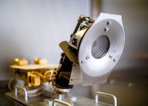 The Solar Probe Cup is a Faraday Cup that looks directly at the Sun and measures ion and electron fluxes and flow angles as a function of energy. A small strut places SPC at the edge of the spacecraft heat shield. (Photo Credit: Andrew Wang)