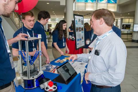 Students attending the UAH’s InSPIRESS event meet with Pete Paceley, general manager of Draper’s Huntsville office. (Credit: University of Alabama at Huntsville)
