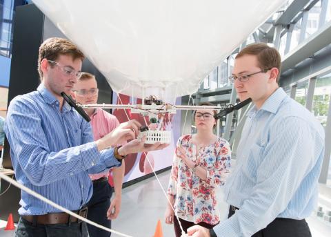 A blimp guided by a cellphone, and capable of delivering a precision payload, served as the summer internship project for eight engineering students working on teams in Massachusetts and Florida.